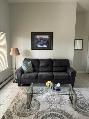 a living room with a couch and a glass table at 3 Bed - Best View in Town! in Surrey