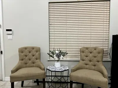 two chairs and a table with a vase of flowers at 3 Bed - Best View in Town! in Surrey