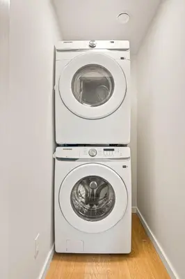 a white washer and dryer in a room at Cozy 2BR BSMT Suite with Board Games and Netflix in Calgary