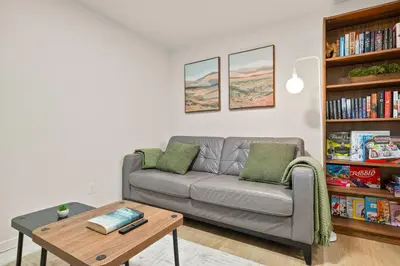 a living room with a couch and a coffee table at Cozy 2BR BSMT Suite with Board Games and Netflix in Calgary