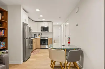 a kitchen with a table and chairs in a room at Cozy 2BR BSMT Suite with Board Games and Netflix in Calgary
