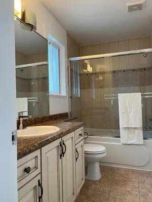 a bathroom with a toilet and a tub and a sink at Luxury New 5-bedroom 4- bathroom Single House in Surrey