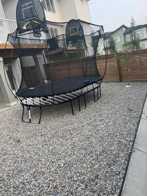 a swing in a yard in front of a house at Cozy & Large Furnished 2-Bedroom Suite in Calgary