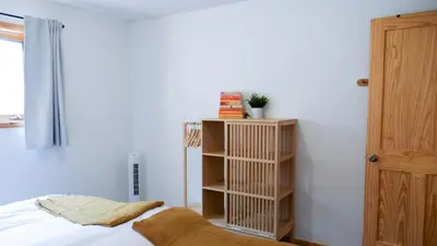 a bedroom with a bed and a book shelf at Lay Back Lodge in Kimberley