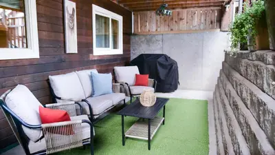 a patio with two chairs and a table on a building at Lay Back Lodge in Kimberley