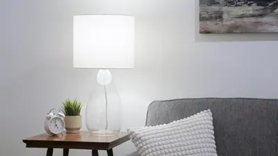 a lamp sitting on a table next to a couch at Lay Back Lodge in Kimberley