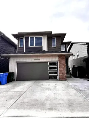 a house with a garage and a driveway at Homey Basement Suite by Gaudi in Calgary