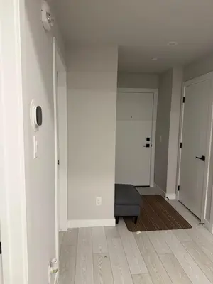 an empty room with a couch and a door at Calgary place in Calgary