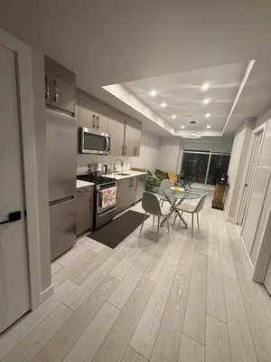 a kitchen and dining room with a table and chairs at Calgary place in Calgary