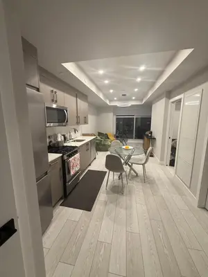 a kitchen with a table and chairs in a room at Calgary place in Calgary