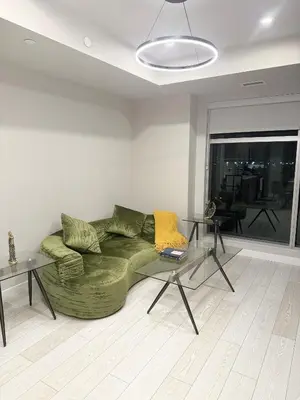 a living room with a green couch and a glass table at Calgary place in Calgary