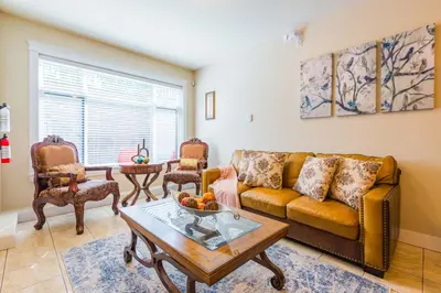a living room with a couch and a table at Beach Breeze White Rock in White Rock