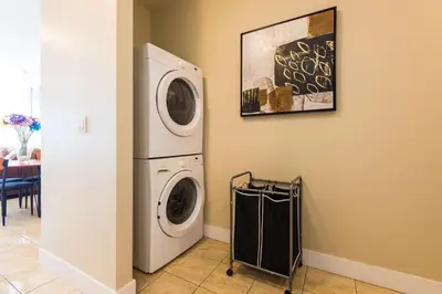 a laundry room with a washer and dryer at Beach Breeze White Rock in White Rock