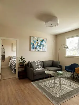 a living room with a couch and a table at Oceana Retreat Cozy 1BR with Outdoor Oasis in Victoria