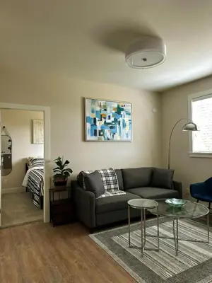 a living room with a couch and a table at Oceana Retreat Cozy 1BR with Outdoor Oasis in Victoria