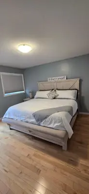 a bedroom with a large bed in a room at Northern Manor in Yellowknife