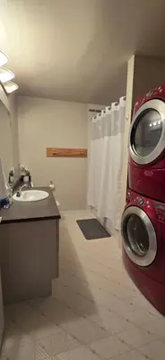 a bathroom with a sink and a washing machine at Northern Manor in Yellowknife