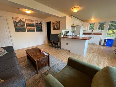 a living room with a couch and a table at Lake View Suite, Forest Retreat, Balfour BC in Balfour