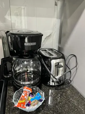 a counter top with a coffee maker and a toaster at One bedroom private entrance suite in Edmonton