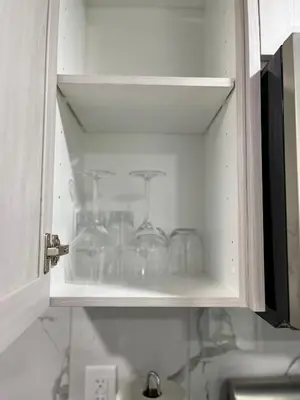 a kitchen cabinet with glass jars in it at One bedroom private entrance suite in Edmonton