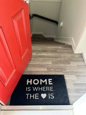 a red door with a home is where the is rug at One bedroom private entrance suite in Edmonton