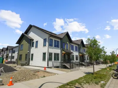 a row of houses on a city street at Exquisite 1-Bdr Condo Apt in Calgary