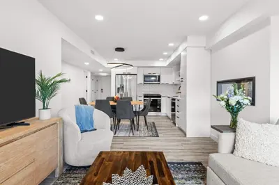 a living room with a couch and a table at Newly Built 2BR and 2BA MtnView Retreat in DT Canmore in Canmore