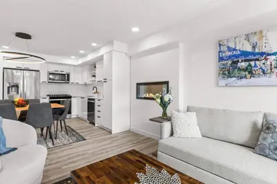 a living room with a couch and a table at Newly Built 2BR and 2BA MtnView Retreat in DT Canmore in Canmore