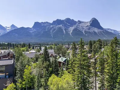 a view of a town with mountains in the background at Newly Built 2BR and 2BA MtnView Retreat in DT Canmore in Canmore