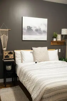 a bedroom with a large bed with white sheets at The Inlet Haven - 2 Bedroom on the Inlet in Ucluelet