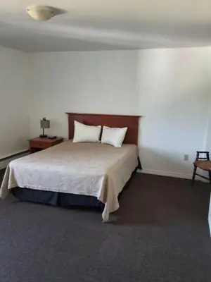 a bedroom with a bed with two pillows on it at Wildwood Hotel in Wildwood