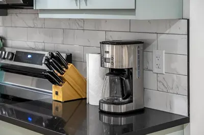 a coffee maker on a counter in a kitchen at Private Sherwood Suite by Park in Calgary