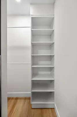 a walk in closet with white shelves at Private Sherwood Suite by Park in Calgary