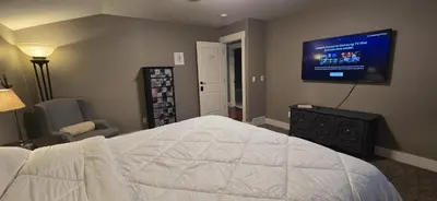 a bedroom with a bed and a flat screen tv at Rocky View Bed & Breakfast in Calgary