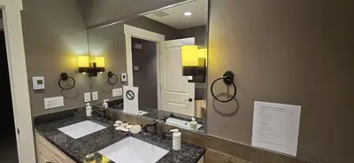 a bathroom with two sinks and a large mirror at Rocky View Bed & Breakfast in Calgary