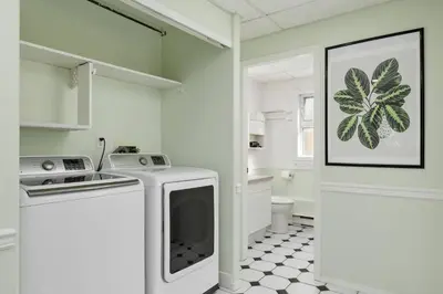 a white kitchen with a stove and a sink at Cozy and Relaxing Private Getaway Free Parking in Nanaimo