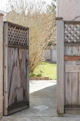an old wooden gate and a wooden door at Cozy and Relaxing Private Getaway Free Parking in Nanaimo