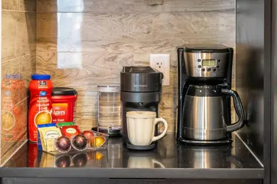 a coffee maker sitting on top of a kitchen counter at NEW Restful Retreat with Hot Tub, King Bed, AC, Garage, Near WEM in Edmonton