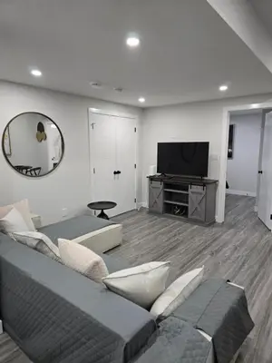 a living room with a couch and a television at The Willow Nest lower suite-2 Rooms in Calgary