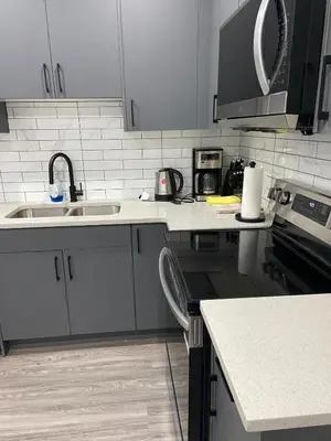 a kitchen with a sink and a counter top at The Willow Nest lower suite-2 Rooms in Calgary