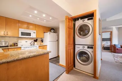 a kitchen with a washer and dryer at Marquise 610 by Outpost Whistler in Whistler