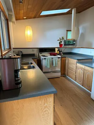 a kitchen with a sink and a stove at Ocean Vista In the Woods on Saltspring Island in Salt Spring Island
