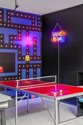a ping pong table in front of a game room at Cowboy Chalet SE|AC|Games|King Bed|20 min to DT in Calgary