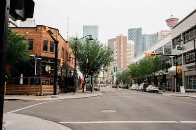 an empty street in a city with tall buildings at City Views Walk to Calgary Tower and Stampede in Calgary