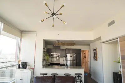 a kitchen with a ceiling fan and a kitchen island at City Views Walk to Calgary Tower and Stampede in Calgary
