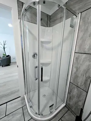 a shower with a glass door in a bathroom at The Oasis in Stettler! in Stettler