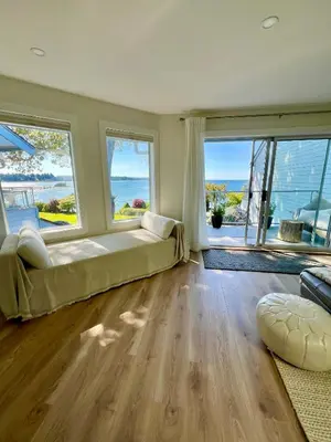 a large bedroom with a large bed and large windows at High Tide Suite - New Bright Oceanfront Escape with Spa-like Bath in Nanoose Bay