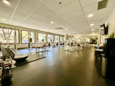 a large room with a gym with many chairs at High Tide Suite - New Bright Oceanfront Escape with Spa-like Bath in Nanoose Bay