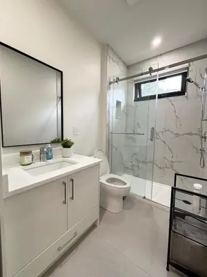 a bathroom with a shower and a toilet and a sink at South surrey Secondary Suite with Kitchen in Surrey