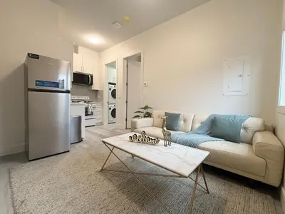 a living room with a couch and a refrigerator at South surrey Secondary Suite with Kitchen in Surrey